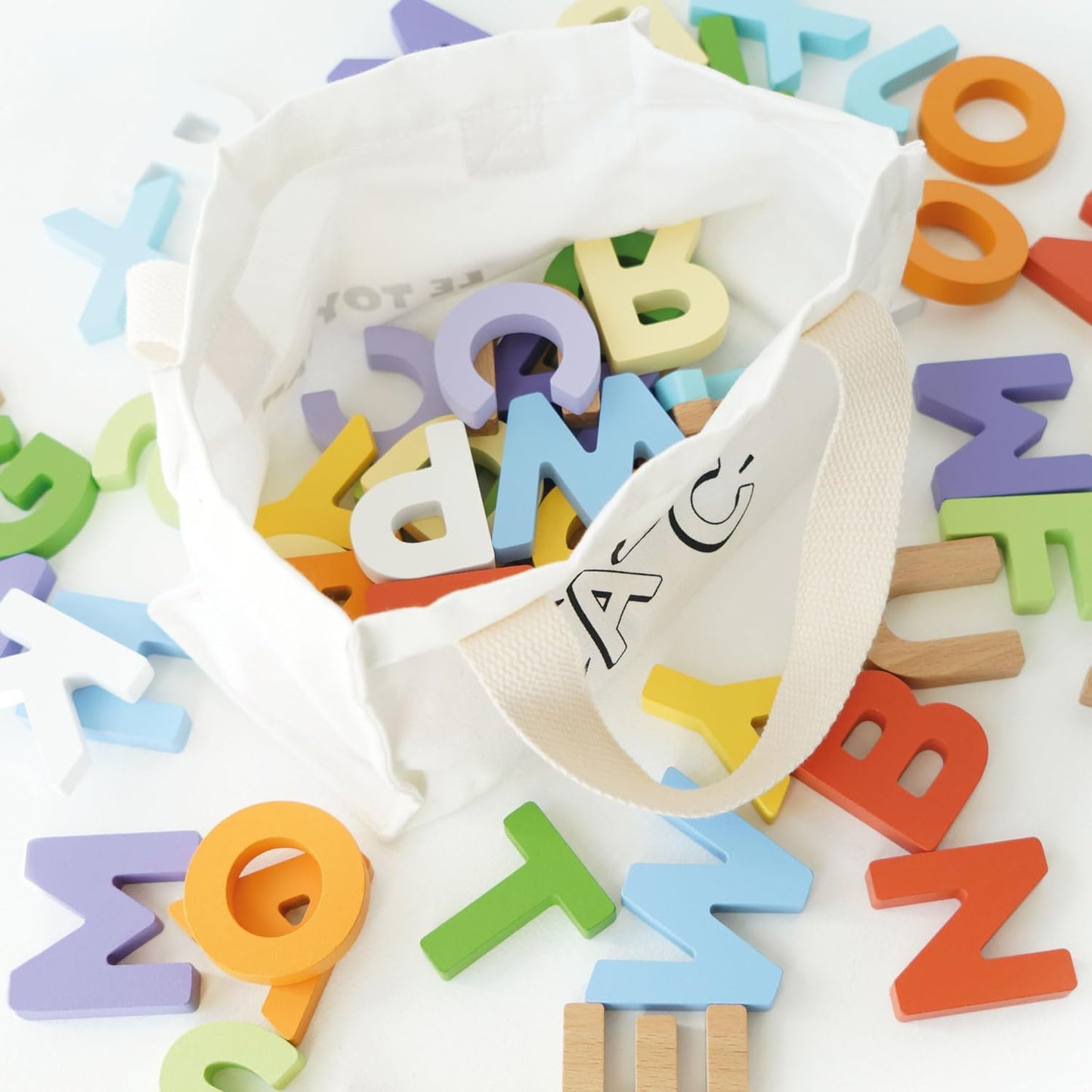 Le Toy Van - Wooden Letters in a Bag Toy, Plastic Free | Suitable for Age 18+ Months